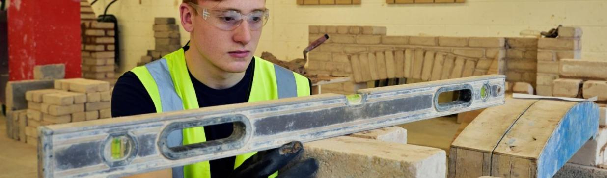 WMC Brickwork Part-Time student measuring inside of a classroom