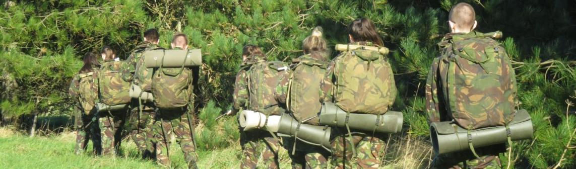 A group of WMC Military Preparation Certificate students wearing camouflage on a field