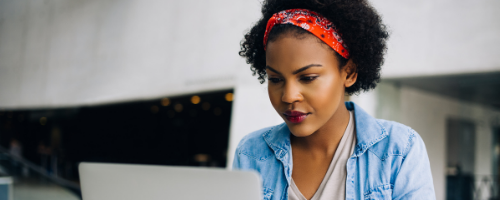 Woman sitting down using laptop 